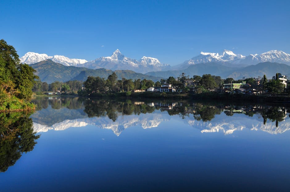Stunning view of the Himalayas reflected in Phewa Lake, Pokhara, Nepal.