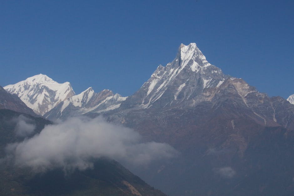 Scenic view of the Annapurna mountain range in Nepal's Koshi Province with clear blue skies.